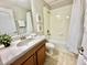 Bathroom with single vanity, bathtub, and neutral tile at 8848 Candy Palm Rd, Kissimmee, FL 34747