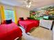 bedroom with three twin beds and a fun mural at 8848 Candy Palm Rd, Kissimmee, FL 34747