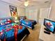 ' bedroom with two twin beds and superhero theme at 8848 Candy Palm Rd, Kissimmee, FL 34747