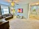 Gathering room with sectional sofa and wall-mounted TV at 8848 Candy Palm Rd, Kissimmee, FL 34747