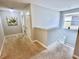 Upstairs hallway with neutral carpeting and access to bedrooms at 8848 Candy Palm Rd, Kissimmee, FL 34747