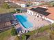 Community pool with solar heating, spa, and ample lounge chairs at 133 Summer Place Loop, Clermont, FL 34714