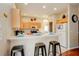 Kitchen with light wood cabinets, an island, and a breakfast bar at 133 Summer Place Loop, Clermont, FL 34714