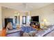 Living room with leather sofas, wood floors, and a large TV at 133 Summer Place Loop, Clermont, FL 34714