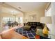Living room with leather sectional sofa, wood floors, and adjacent dining area at 133 Summer Place Loop, Clermont, FL 34714