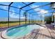 Private kidney-shaped pool with screened enclosure and patio furniture at 133 Summer Place Loop, Clermont, FL 34714
