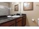 Bathroom with granite countertop and dark wood cabinets at 1351 Tuscan Ter # 8401, Davenport, FL 33896
