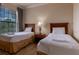 Bedroom with two twin beds and wood flooring at 1351 Tuscan Ter # 8401, Davenport, FL 33896