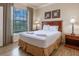 Bedroom with a queen bed and wood flooring at 1351 Tuscan Ter # 8401, Davenport, FL 33896