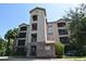 Exterior view of a multi-story building with stone accents at 1351 Tuscan Ter # 8401, Davenport, FL 33896