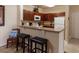 Kitchen with breakfast bar and dark wood cabinets at 1351 Tuscan Ter # 8401, Davenport, FL 33896