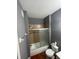 This bathroom features a tiled shower, gray walls, and a standard toilet at 13560 Turtle Marsh Loop # 319, Orlando, FL 32837