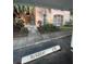 Condo building exterior with parking and walkway under tropical trees at 13560 Turtle Marsh Loop # 319, Orlando, FL 32837