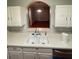 Kitchen sink and countertop leading to living room and light at 13560 Turtle Marsh Loop # 319, Orlando, FL 32837