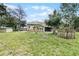 Spacious backyard with large lawn, shed, and partially visible house at 1437 Pecos Dr, Ormond Beach, FL 32174