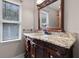 Bathroom with granite countertop and wood vanity at 1437 Pecos Dr, Ormond Beach, FL 32174