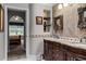 Double vanity bathroom with granite countertops and decorative mirrors at 1437 Pecos Dr, Ormond Beach, FL 32174