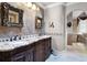 Large bathroom with granite countertops and ornate wood cabinets at 1437 Pecos Dr, Ormond Beach, FL 32174