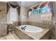 Bathroom with a large garden tub and tiled walls at 1437 Pecos Dr, Ormond Beach, FL 32174