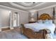 Elegant bedroom with a large wooden bed frame and neutral color scheme at 1437 Pecos Dr, Ormond Beach, FL 32174