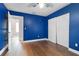 Blue bedroom with wood flooring and double door closet at 1437 Pecos Dr, Ormond Beach, FL 32174