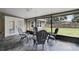 Spacious screened porch with slate tile floor, ceiling fan and French doors at 1437 Pecos Dr, Ormond Beach, FL 32174