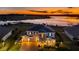 Luxury home aerial view at sunset, showcasing lakefront location and landscaping at 16750 Sanctuary Dr, Winter Garden, FL 34787