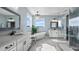 Elegant bathroom with soaking tub, double vanity, and glass shower at 16750 Sanctuary Dr, Winter Garden, FL 34787