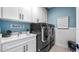 Bright laundry room with white cabinets and new appliances at 16750 Sanctuary Dr, Winter Garden, FL 34787