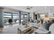 Spacious living room with sliding doors leading to pool and lake views at 16750 Sanctuary Dr, Winter Garden, FL 34787