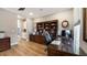 Spacious home office with hardwood floors and built-in wooden desk and cabinets at 16750 Sanctuary Dr, Winter Garden, FL 34787