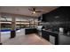 Outdoor kitchen with grill, sink, and lake view at sunset at 16750 Sanctuary Dr, Winter Garden, FL 34787
