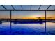 Inviting heated pool with water features and a gorgeous sunset view at 16750 Sanctuary Dr, Winter Garden, FL 34787