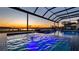 Relaxing pool and spa area with covered lanai, offering a sunset view at 16750 Sanctuary Dr, Winter Garden, FL 34787