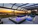Covered lanai with pool and spa featuring sunset views at 16750 Sanctuary Dr, Winter Garden, FL 34787