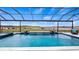 Relaxing pool with a screened enclosure and lake view at 16750 Sanctuary Dr, Winter Garden, FL 34787