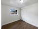 Well-lit bedroom with dark brown tile floors and sliding door closet at 1810 Selleen Dr, Eustis, FL 32726