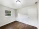 Bright bedroom with dark brown tile floors and large window at 1810 Selleen Dr, Eustis, FL 32726