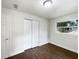 Well-lit bedroom with double door closet and hardwood floors at 1810 Selleen Dr, Eustis, FL 32726