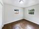 Spacious bedroom with dark brown tile floors and dual windows at 1810 Selleen Dr, Eustis, FL 32726