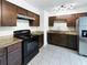 Modern kitchen with granite countertops and dark wood cabinets at 1810 Selleen Dr, Eustis, FL 32726
