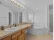 Bathroom boasts a corner tub and updated vanity at 204 Paloma Dr, Davenport, FL 33837