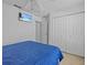 Bedroom with double doors and a wall-mounted TV at 204 Paloma Dr, Davenport, FL 33837