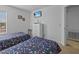 Well-lit bedroom with two twin beds, a dresser, and access to hallway at 204 Paloma Dr, Davenport, FL 33837