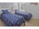 Serene bedroom featuring two twin beds with floral bedding at 204 Paloma Dr, Davenport, FL 33837