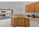 Kitchen with light wood cabinets, stainless steel appliances, and a view of the backyard at 204 Paloma Dr, Davenport, FL 33837