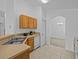 Kitchen with light wood cabinets, stainless steel appliances, and tile floors at 204 Paloma Dr, Davenport, FL 33837