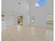 Living room with high ceilings, tile floors, and access to a patio at 204 Paloma Dr, Davenport, FL 33837