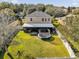 Aerial view showcasing house with screened patio and yard at 20811 Sullivan Ranch Blvd, Mount Dora, FL 32757