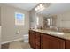 Elegant bathroom with double vanity and granite countertop at 20811 Sullivan Ranch Blvd, Mount Dora, FL 32757